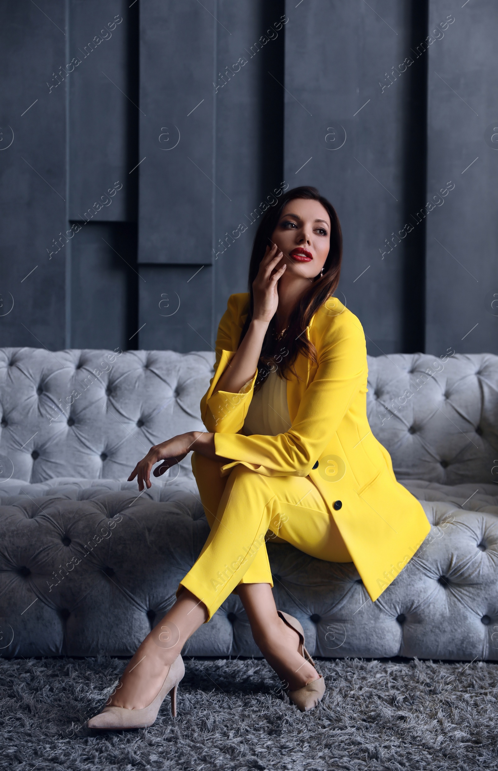 Photo of Beautiful businesswoman on sofa indoors. Luxury lifestyle