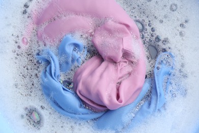 Photo of Color clothing in suds, top view. Hand washing laundry