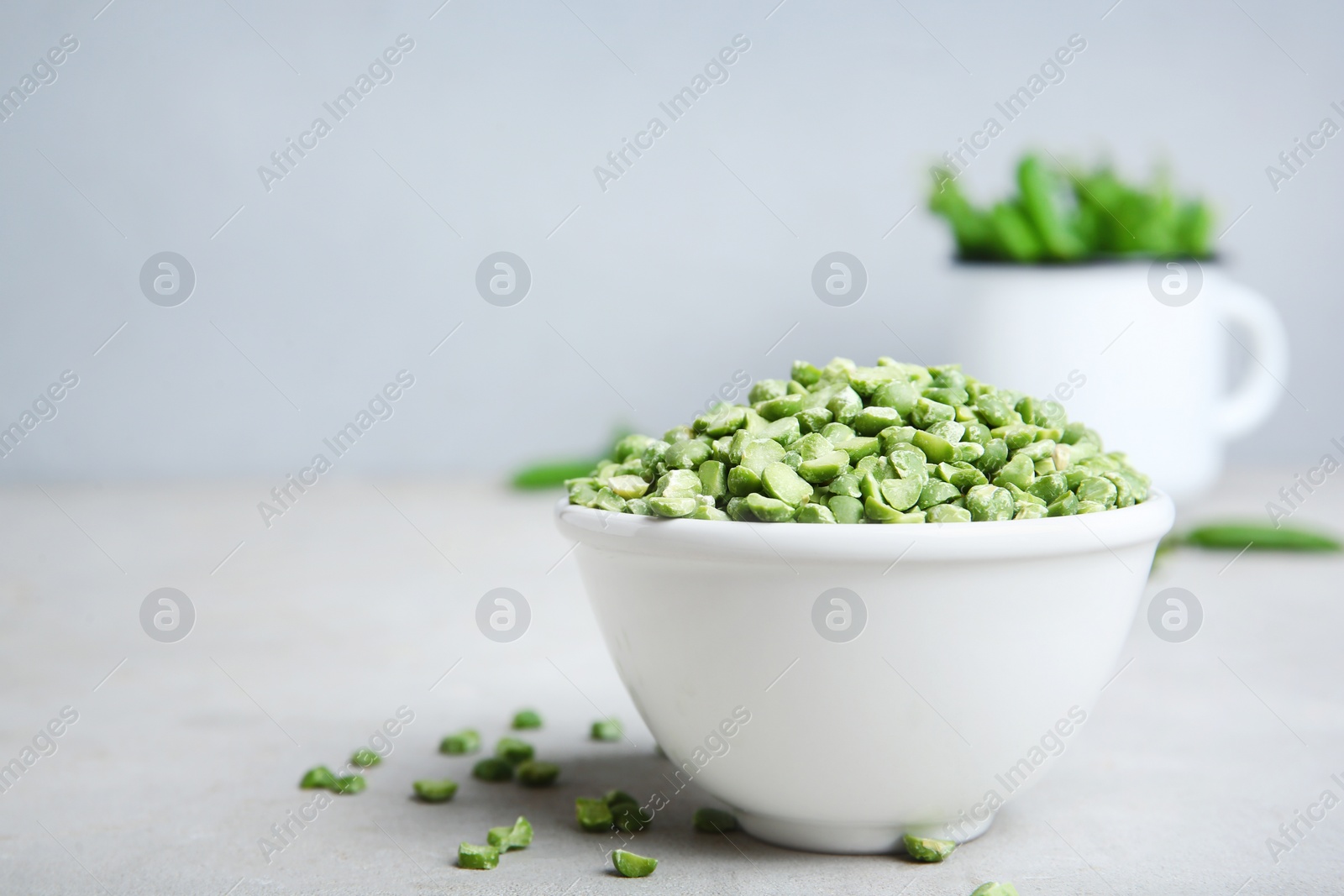 Photo of Ceramic bowl with dried peas on table