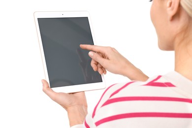 Woman using tablet with blank screen on white background, closeup. Mockup for design