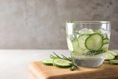 Photo of Glass of fresh cucumber water on table. Space for text