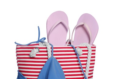 Photo of Beach bag with flip flops and bikini top isolated on white