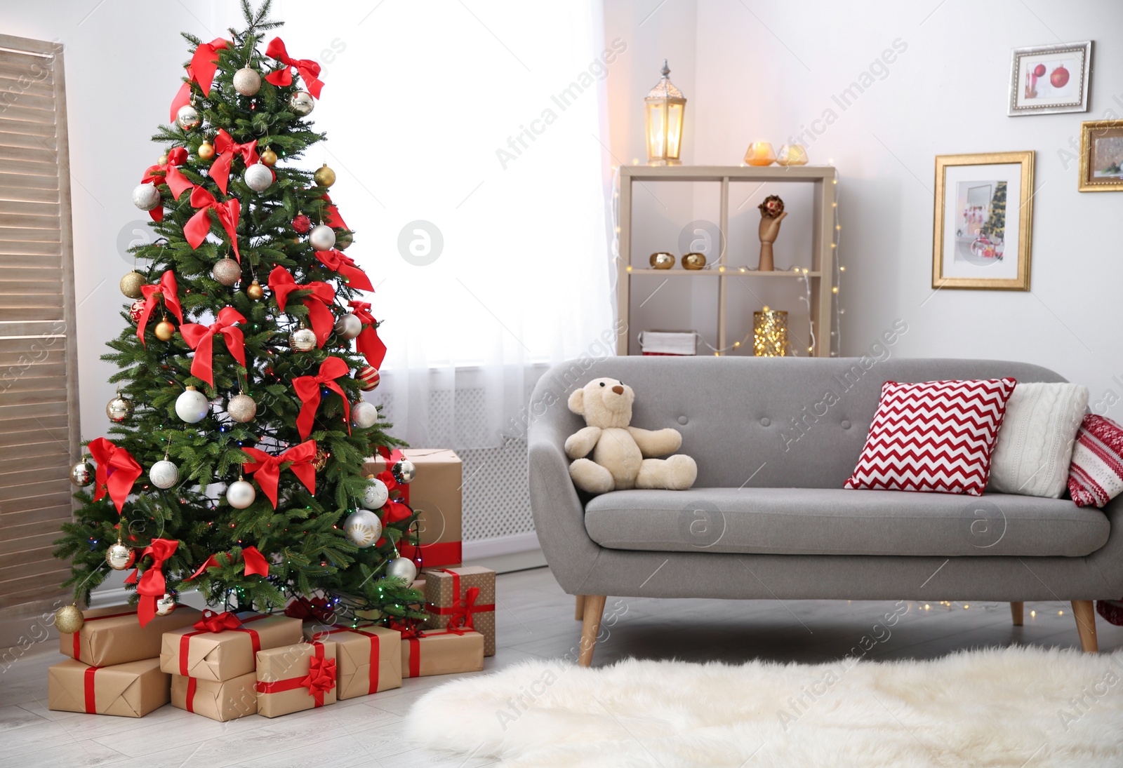 Photo of Room interior with beautiful Christmas tree and gifts