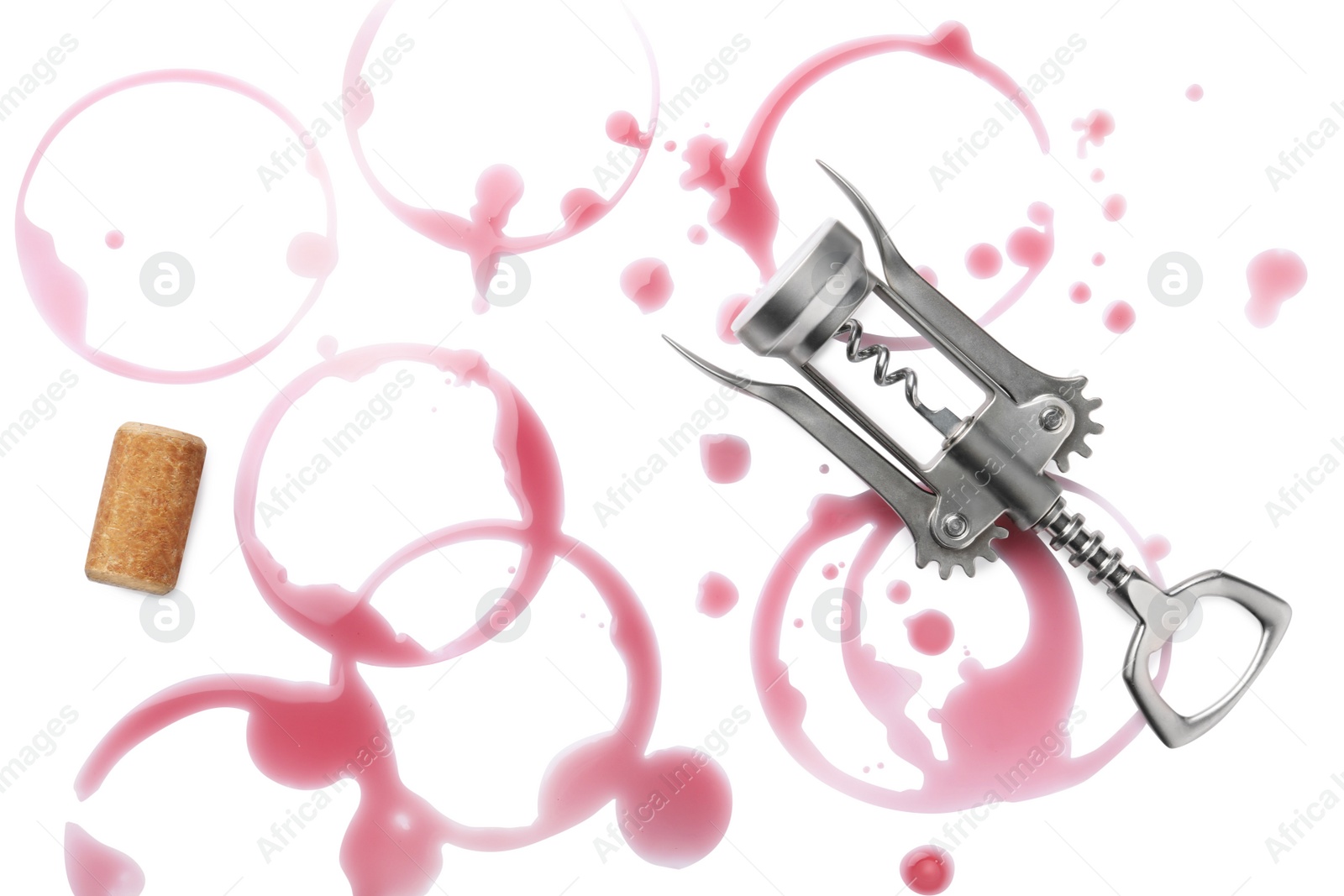 Photo of Red wine rings with drops, bung and metal corkscrew on white background, top view