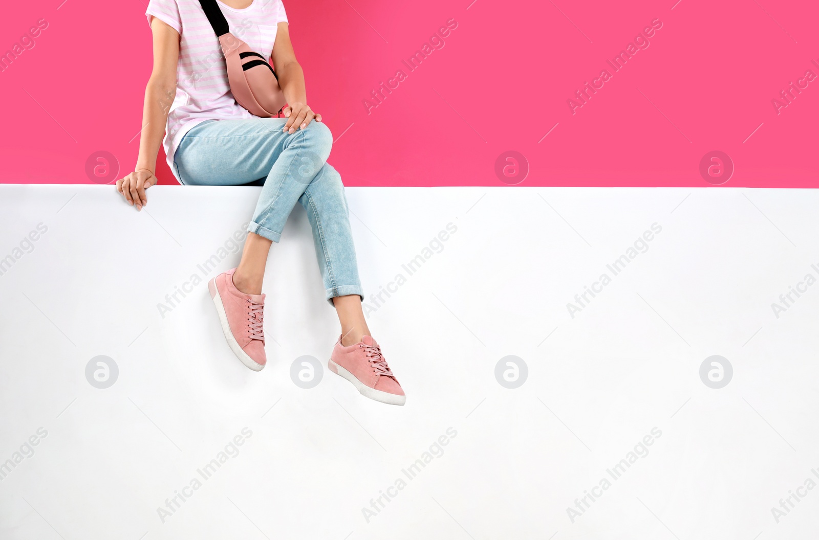 Photo of Woman wearing stylish shoes on color background, closeup