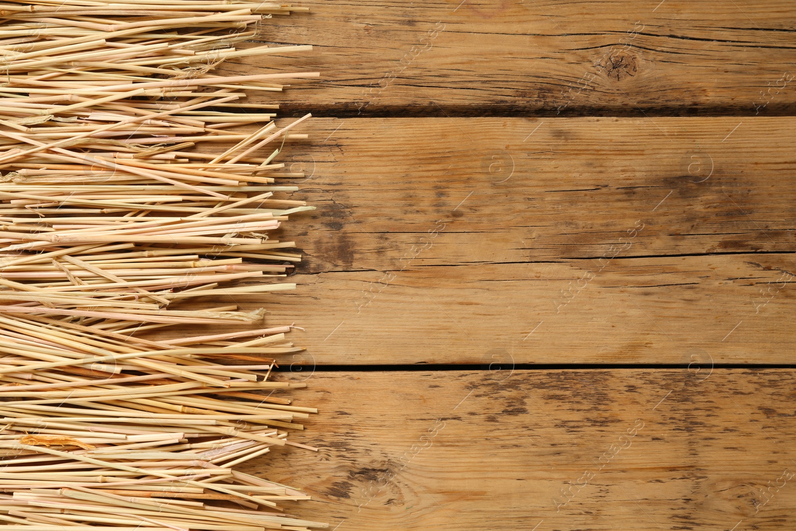 Photo of Dried hay on wooden background, flat lay. Space for text