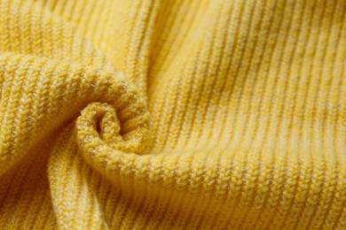 Yellow knitted fabric as background, closeup view