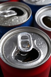 Photo of Energy drinks in wet cans as background, closeup. Functional beverage