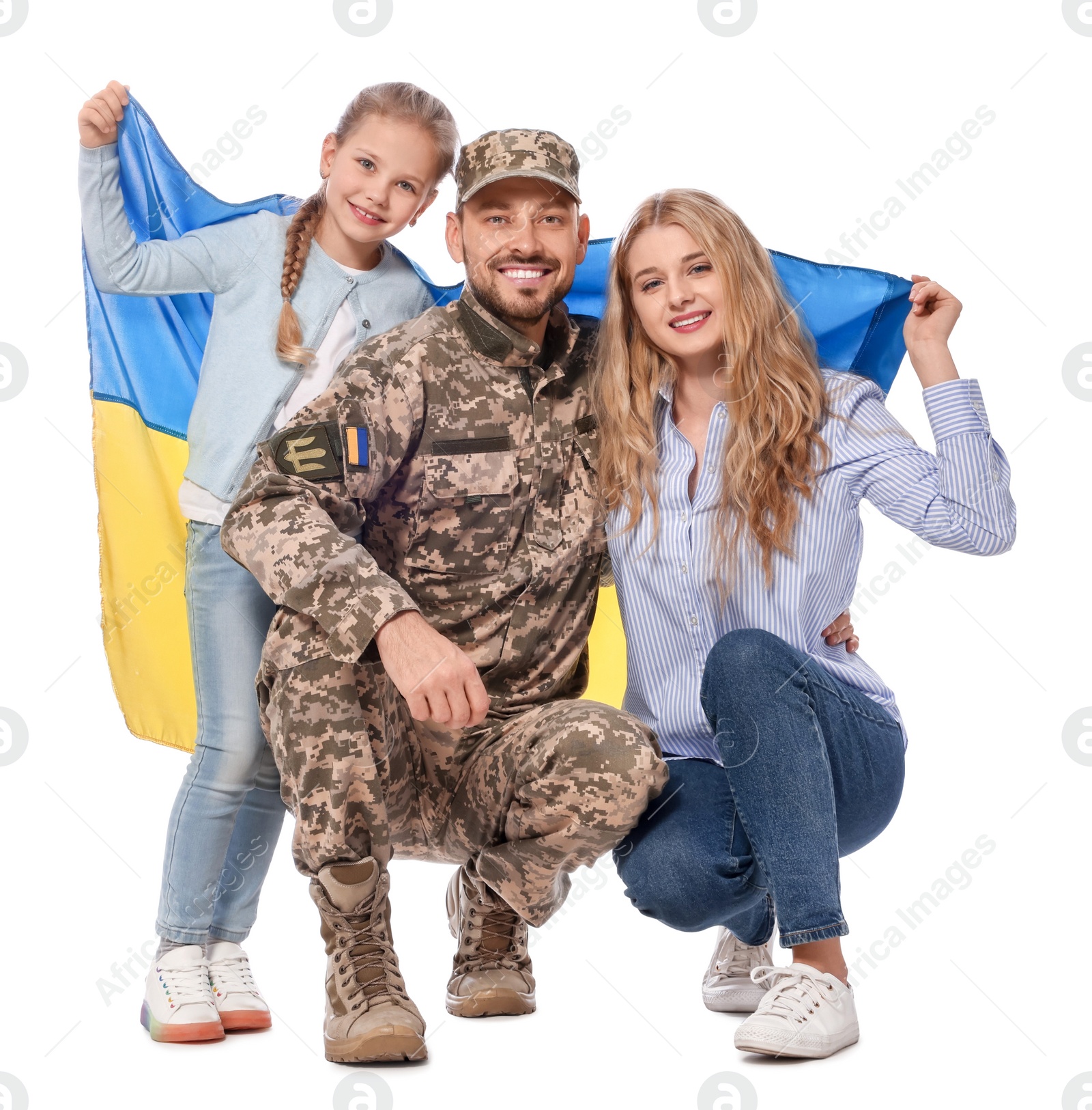 Photo of Soldier in military uniform reunited with his family and Ukrainian flag on white background