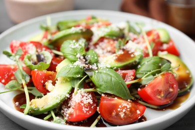 Photo of Tasty salad with balsamic vinegar on plate, closeup