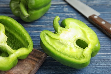 Cut paprika pepper on wooden table, closeup