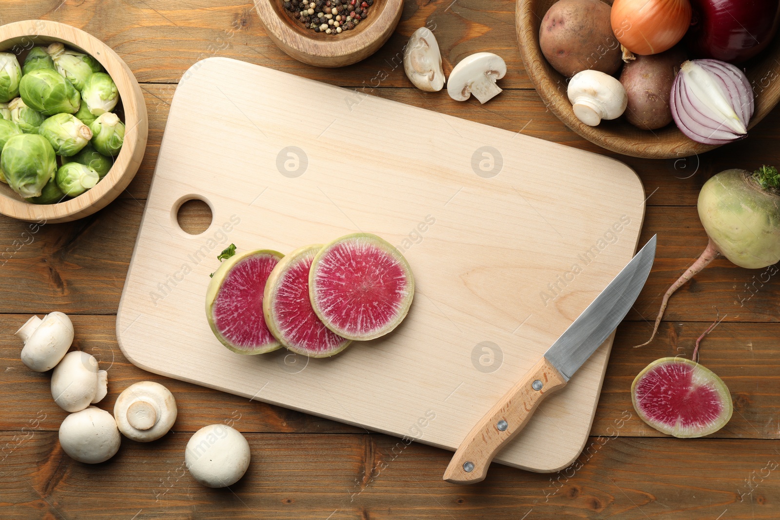 Photo of Flat lay composition with cutting board and products on wooden table