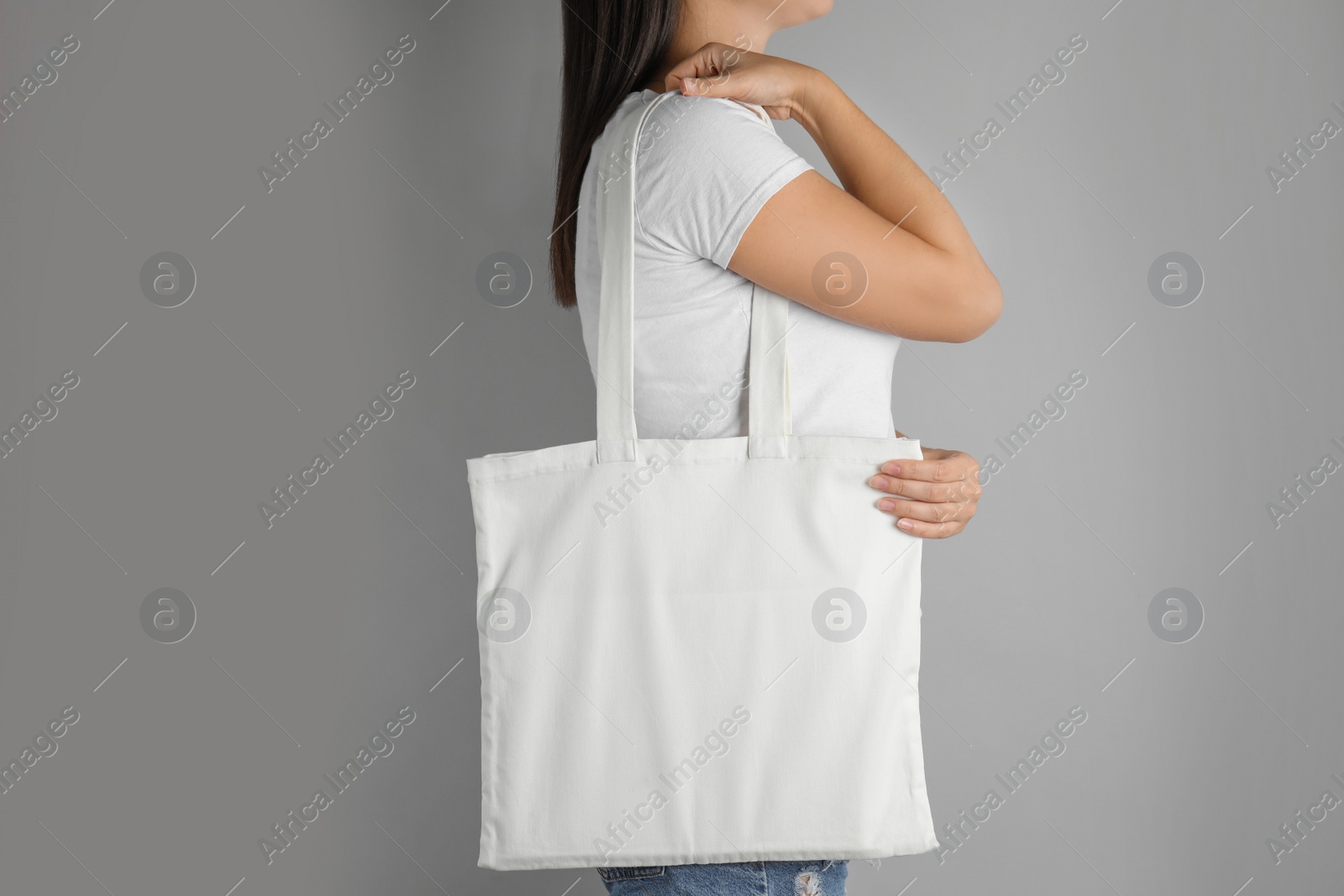 Photo of Woman with tote bag on grey background. Mock up for design