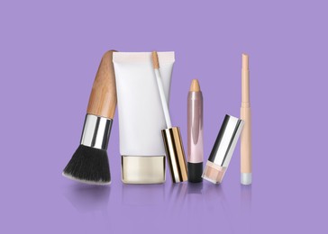 Image of Set with different decorative cosmetics on violet background. Luxurious makeup products