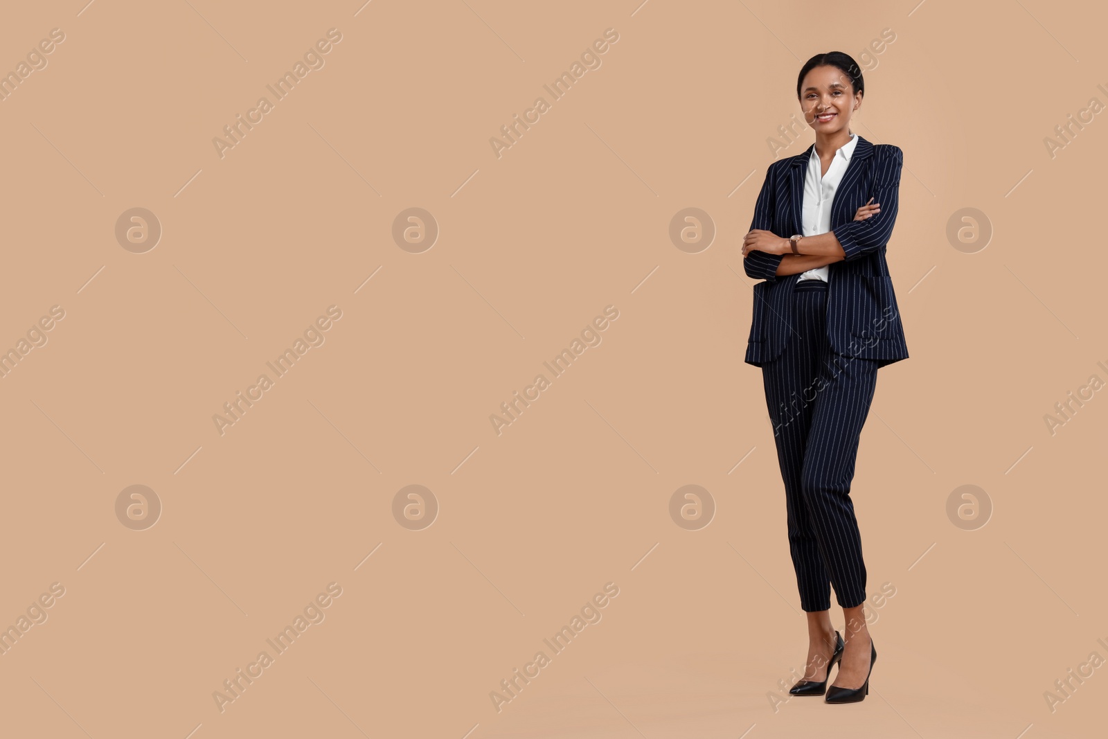 Photo of Beautiful secretary on beige background, space for text