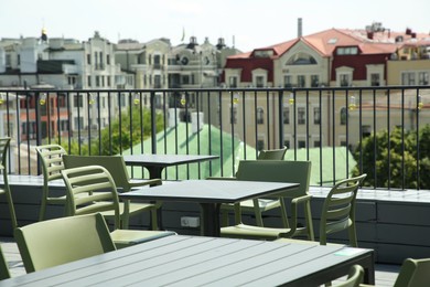 Observation area cafe. Tables and chairs on terrace against beautiful cityscape