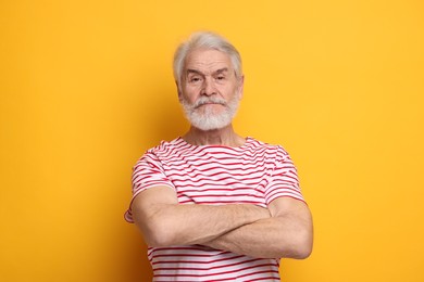 Photo of Senior man with mustache on orange background