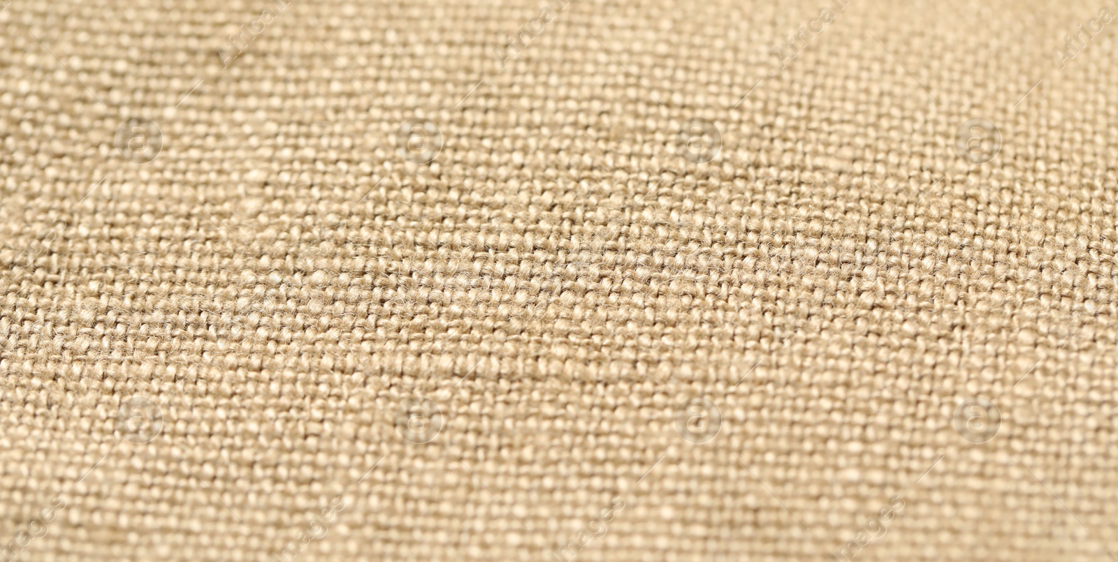 Photo of Texture of beige fabric as background, closeup