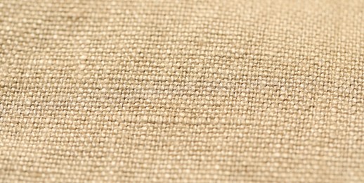 Photo of Texture of beige fabric as background, closeup