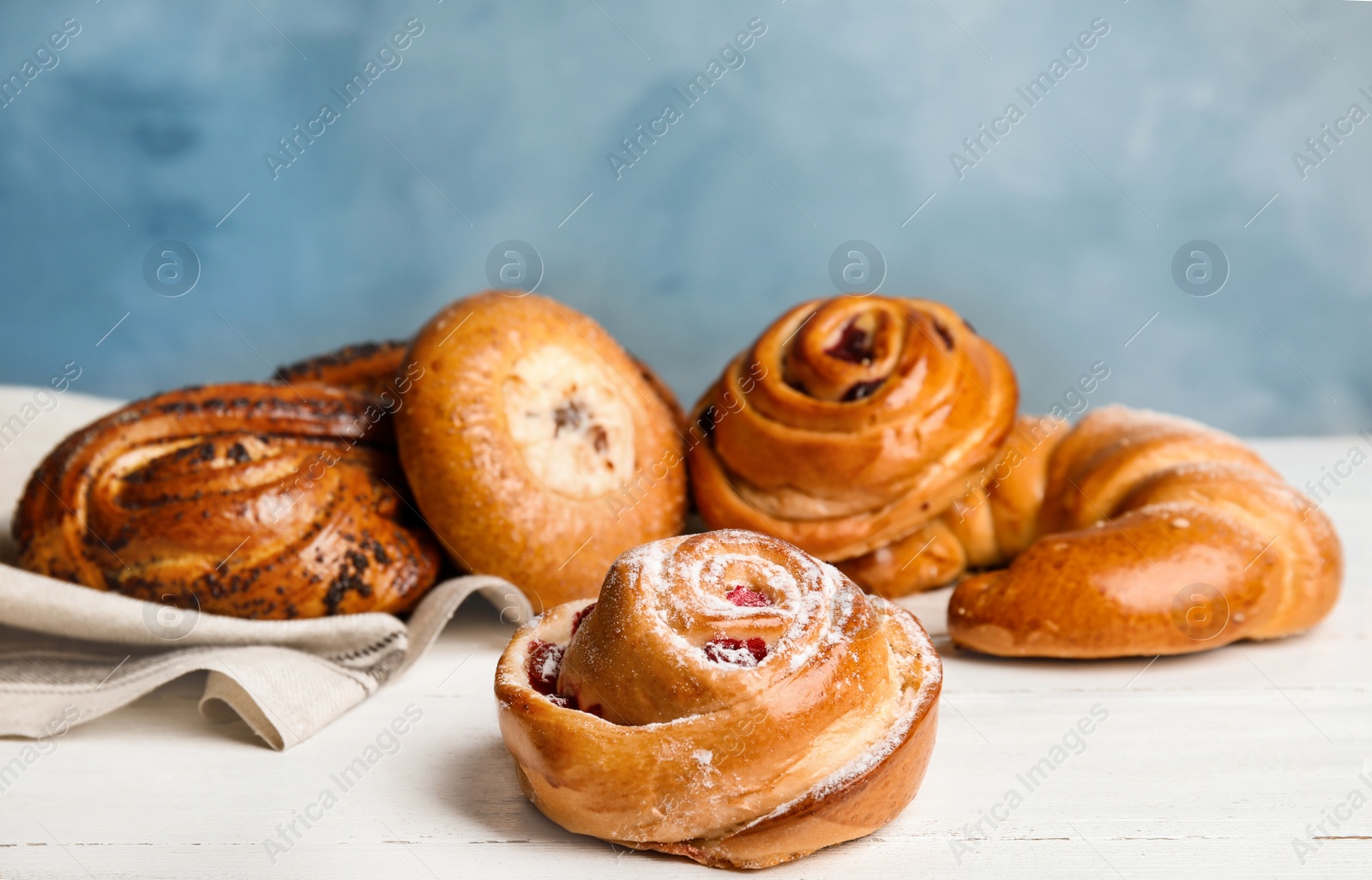 Photo of Different delicious fresh pastries on white wooden table