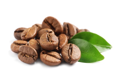 Photo of Roasted coffee beans and fresh green leaves on white background