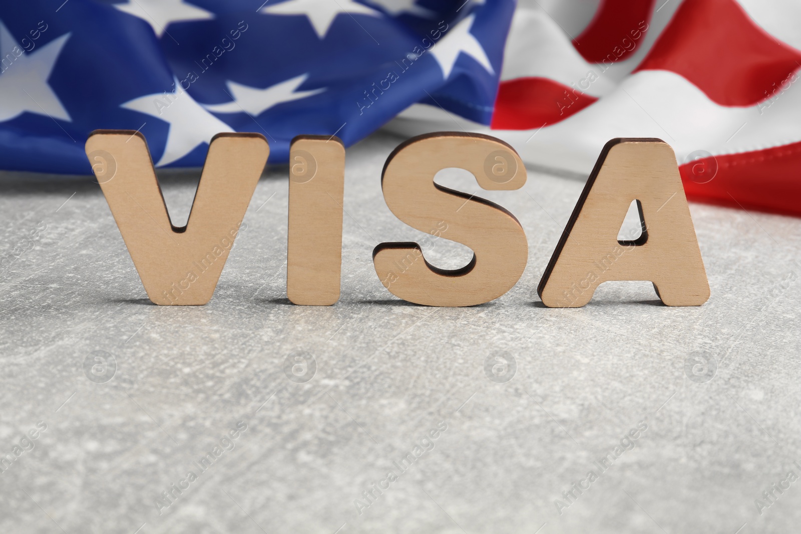 Photo of Word Visa and American flag on light grey table, space for text