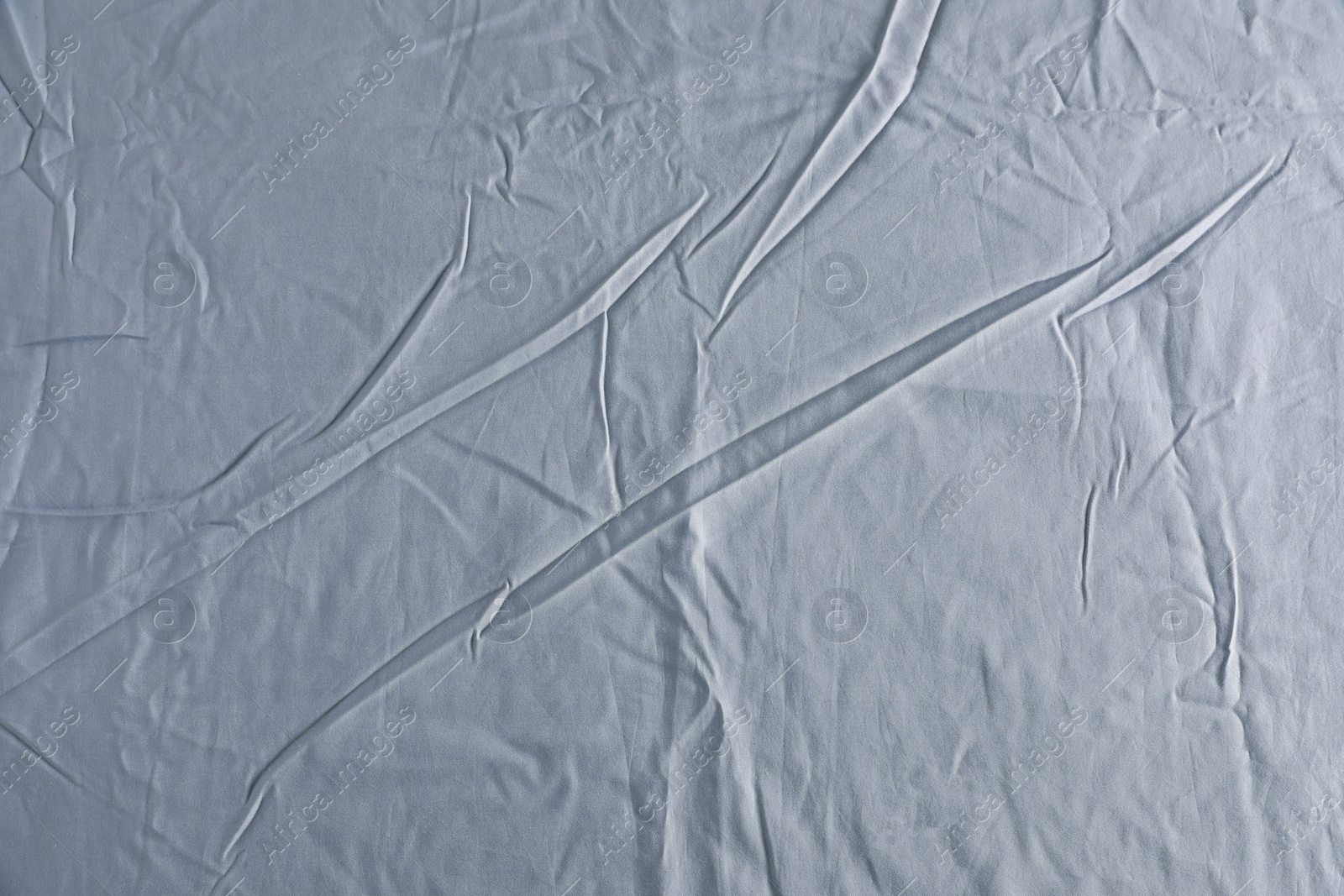 Photo of Crumpled grey fabric as background, top view