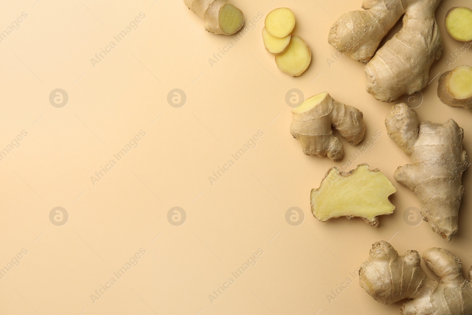 Photo of Fresh ginger on beige background, flat lay. Space for text