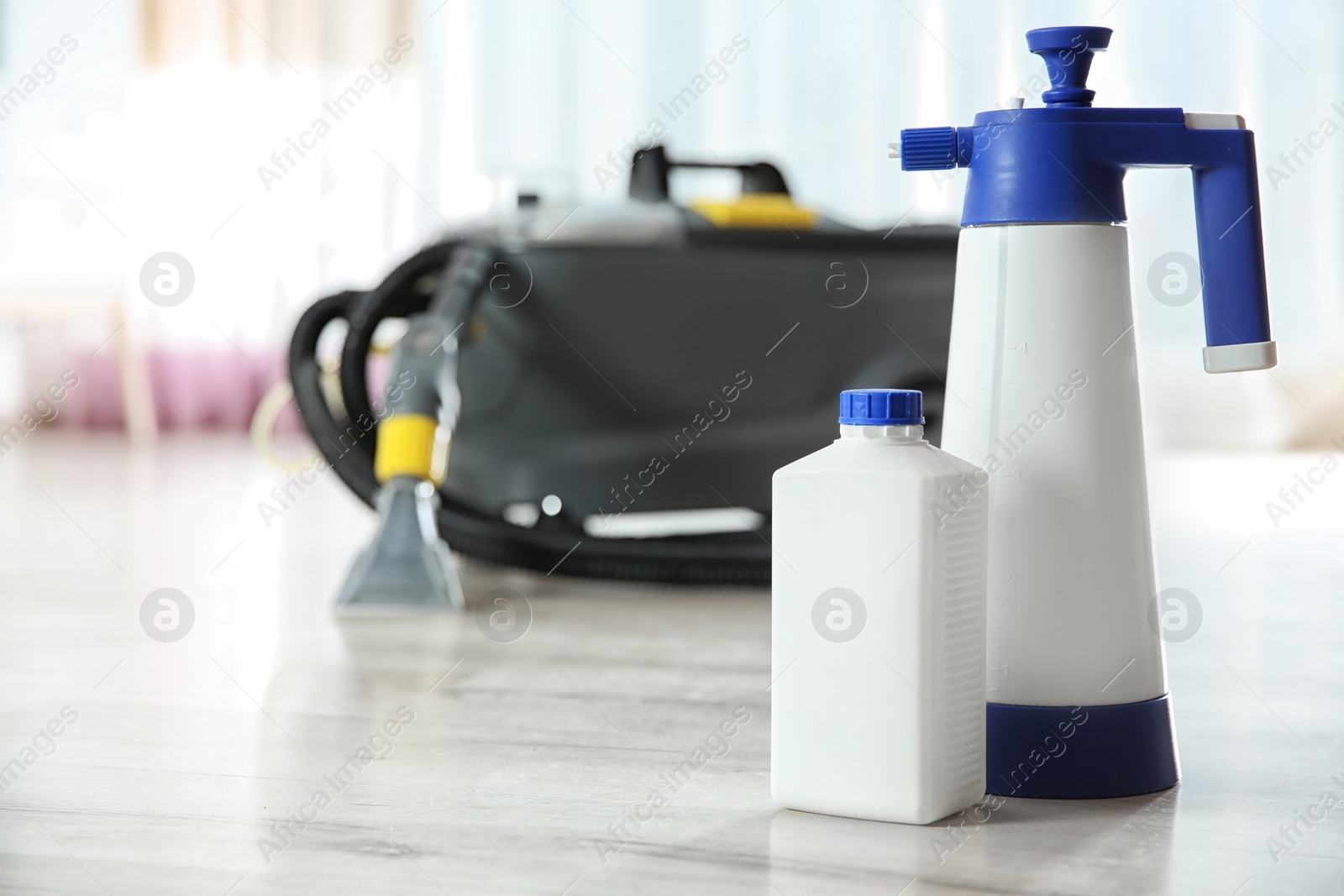 Photo of Professional cleaning supplies and equipment on floor indoors. Space for text