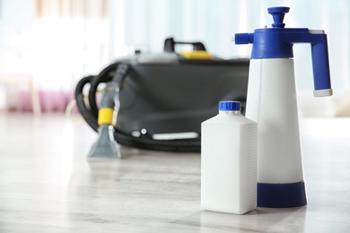 Professional cleaning supplies and equipment on floor indoors. Space for text