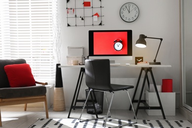 Photo of Modern computer on desk in room. Home workplace