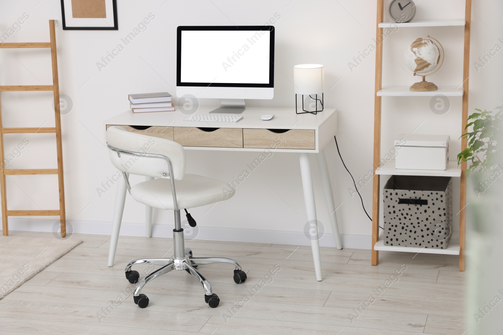 Photo of Workplace with comfortable office chair indoors. Interior design