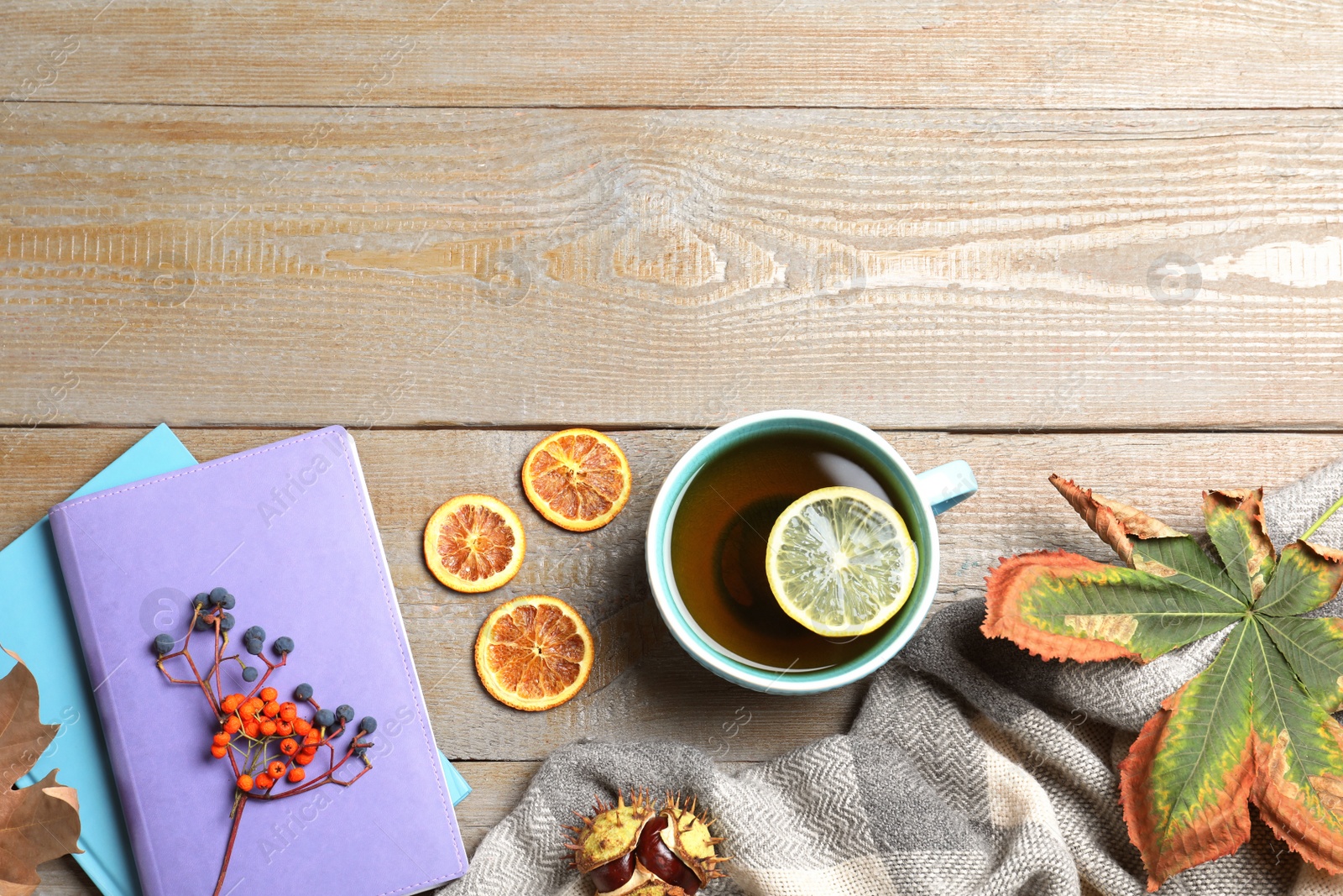 Photo of Flat lay composition with cup of hot drink on wooden table, space for text. Cozy autumn atmosphere