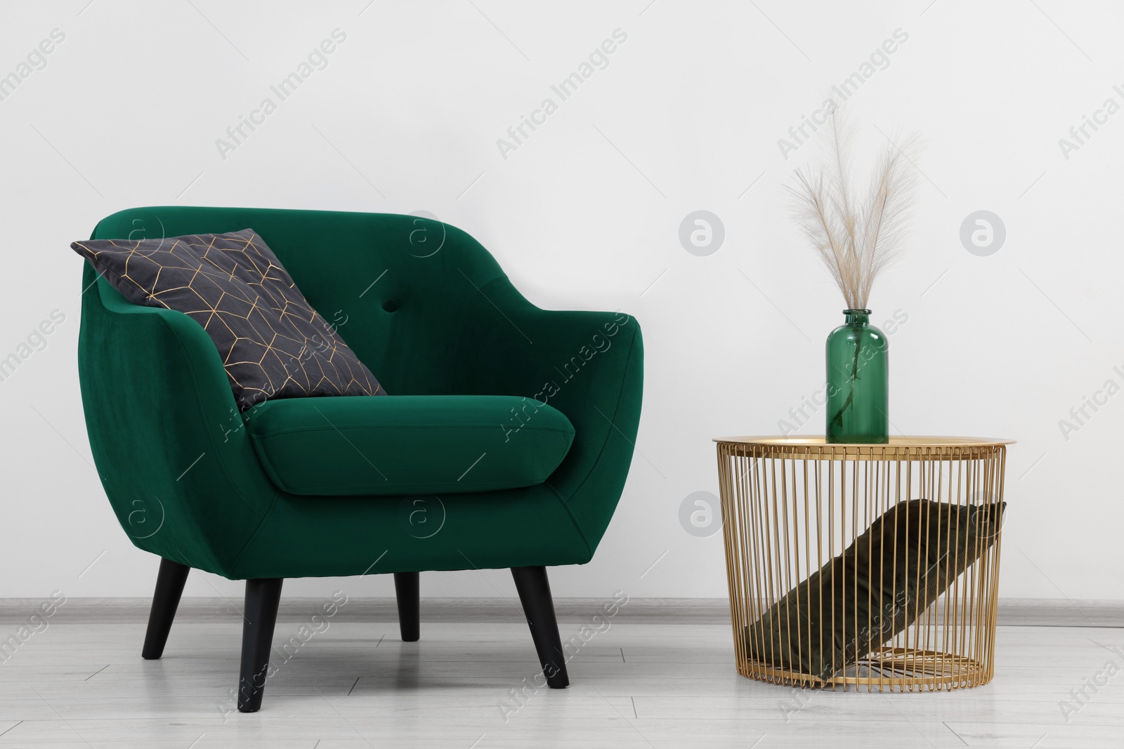 Photo of Stylish room interior with comfortable armchair and side table