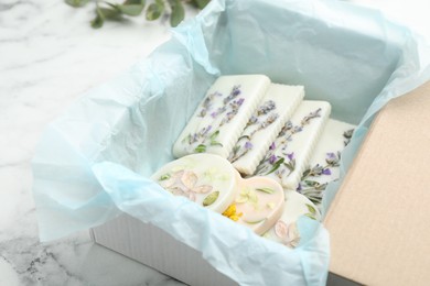Box with scented sachets on white marble table