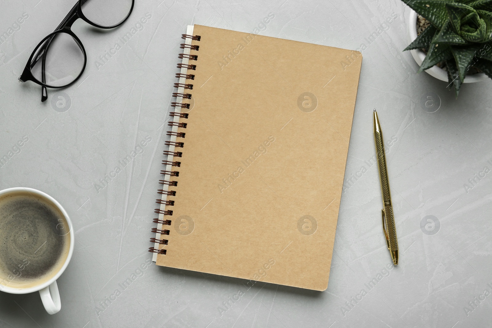 Photo of Flat lay composition with notebook on light textured table