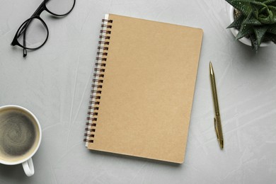 Flat lay composition with notebook on light textured table