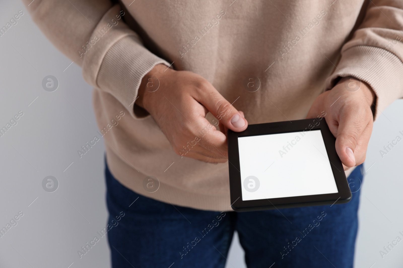 Photo of Man using e-book reader on white background, closeup