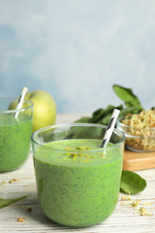 Green buckwheat smoothie on white wooden table