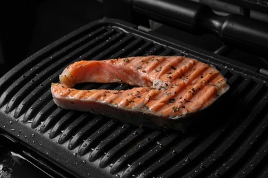 Cooking salmon. Grill with tasty fish steak and spices