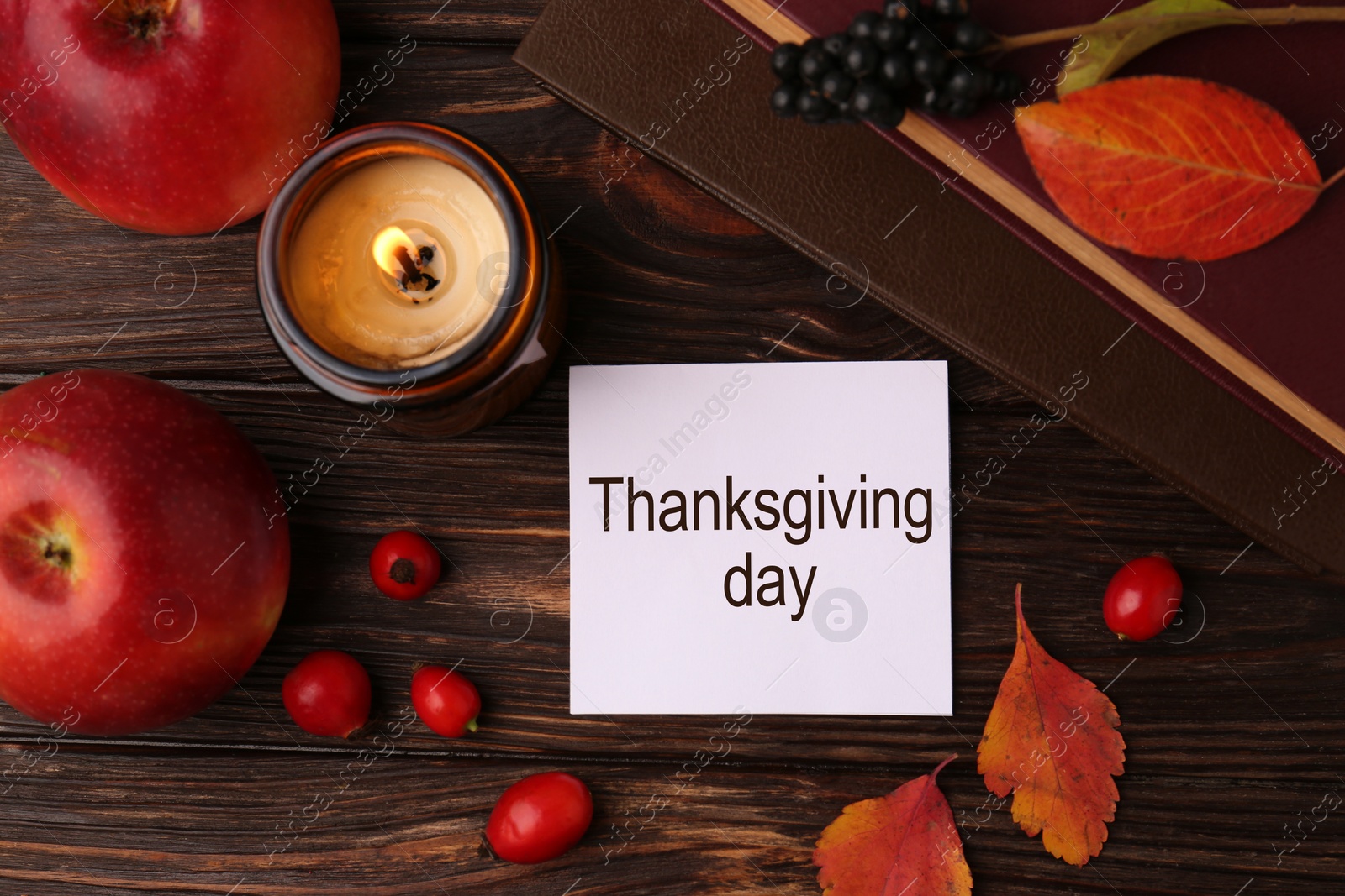 Photo of Thanksgiving Day. Flat lay composition with paper card and autumn leaves on wooden table