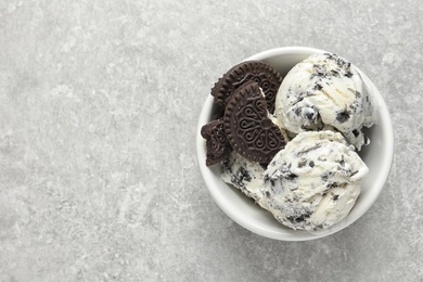Photo of Bowl of chocolate cookies ice cream on grey background, top view with space for text