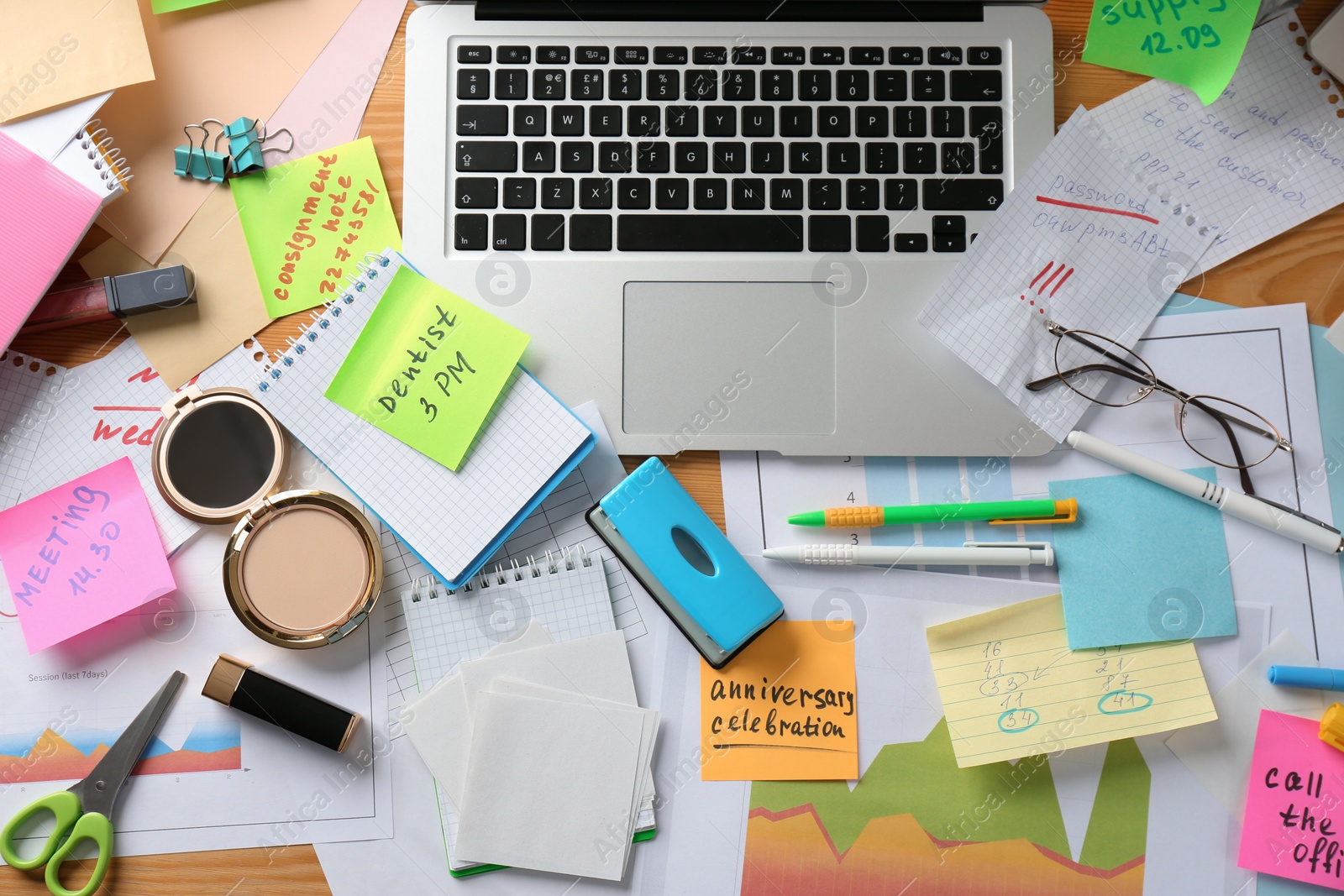 Photo of Messy table with laptop and cosmetics, flat lay. Concept of being overwhelmed by work