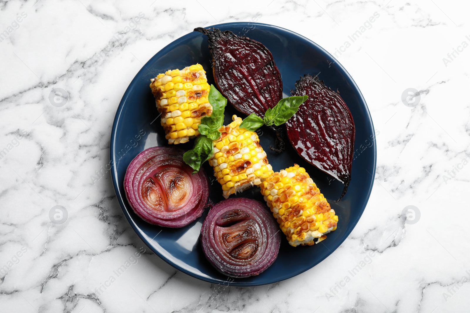 Photo of Delicious grilled vegetables on white marble table, top view