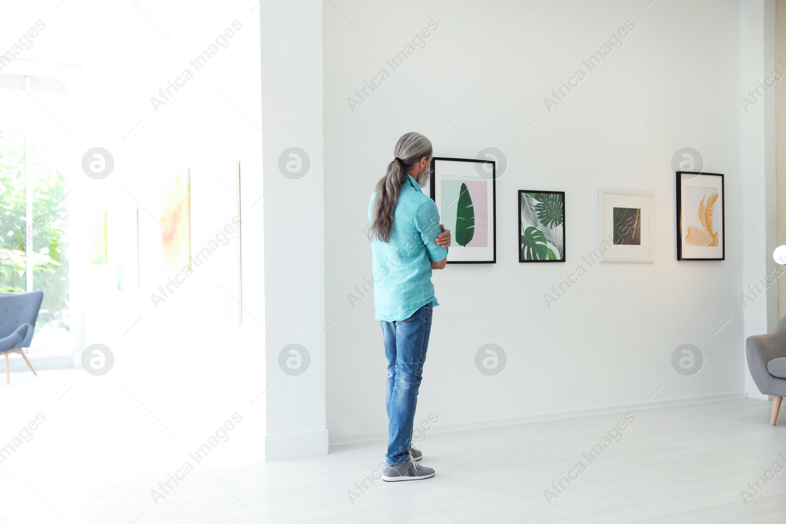 Photo of Senior man at exhibition in art gallery