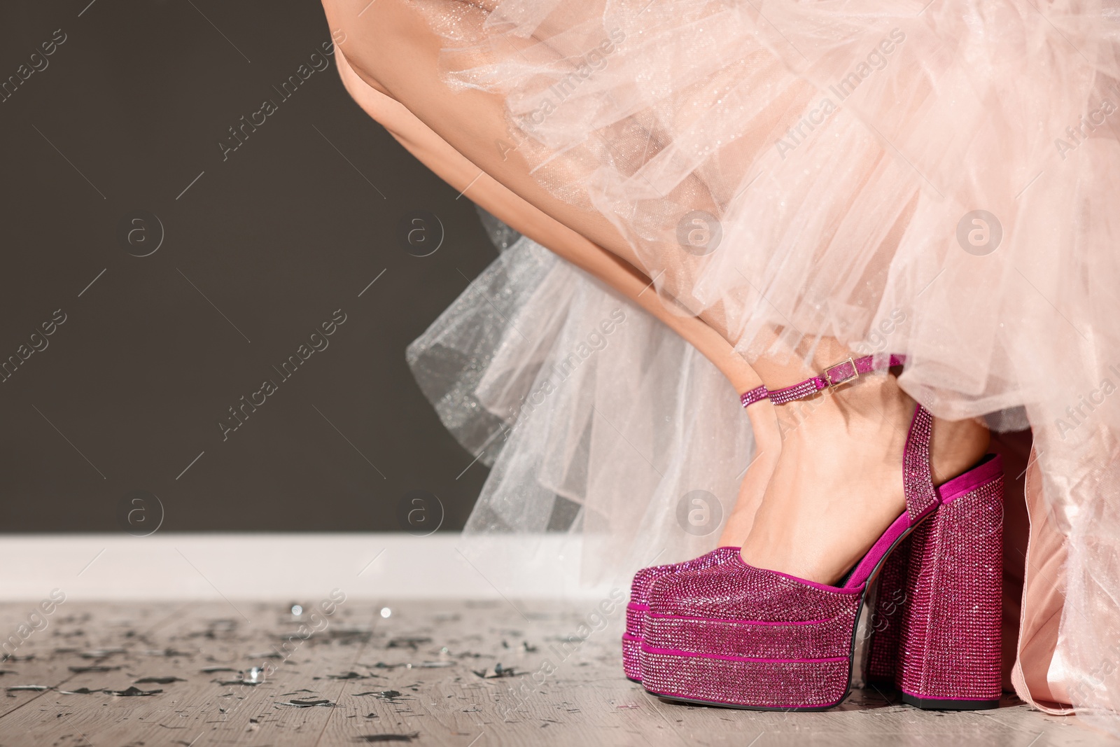 Photo of Stylish party. Woman wearing pink high heeled shoes with platform and square toes indoors, closeup. Space for text