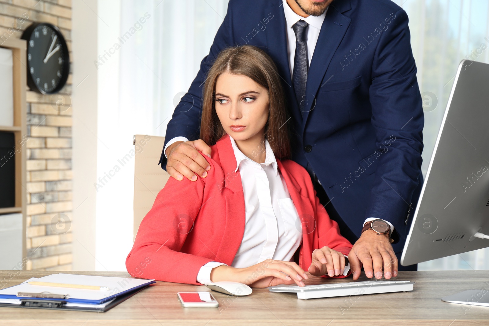 Photo of Boss molesting his female secretary in office. Sexual harassment at work