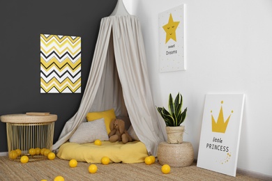 Baby room interior with play tent and cute posters