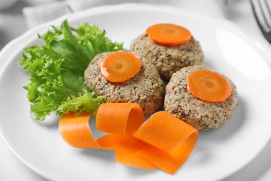Plate of traditional Passover (Pesach) gefilte fish on table, closeup