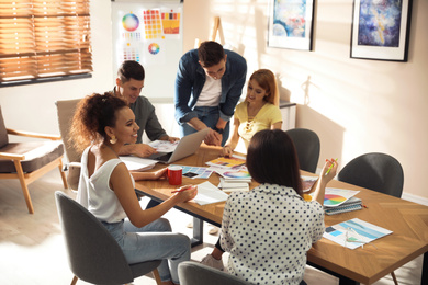 Photo of Team of professional designers working in office